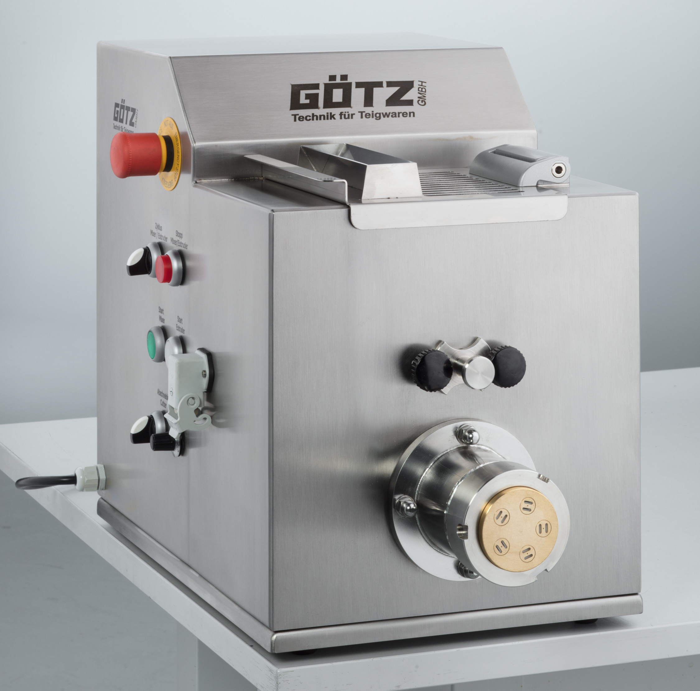The P-05-G Pasta Extruder sitting on a counter in a kitchen.